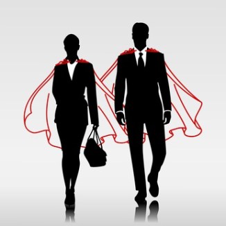 Business heroes couple with red cloak