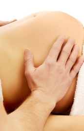 Pregnant woman having a massage on her belly