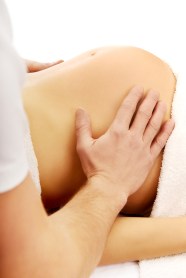 Pregnant woman having a massage on her belly