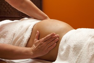 Young pregnant woman receiving relaxing massage