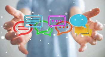 Businessman using digital colorful 3D rendering conversation icons